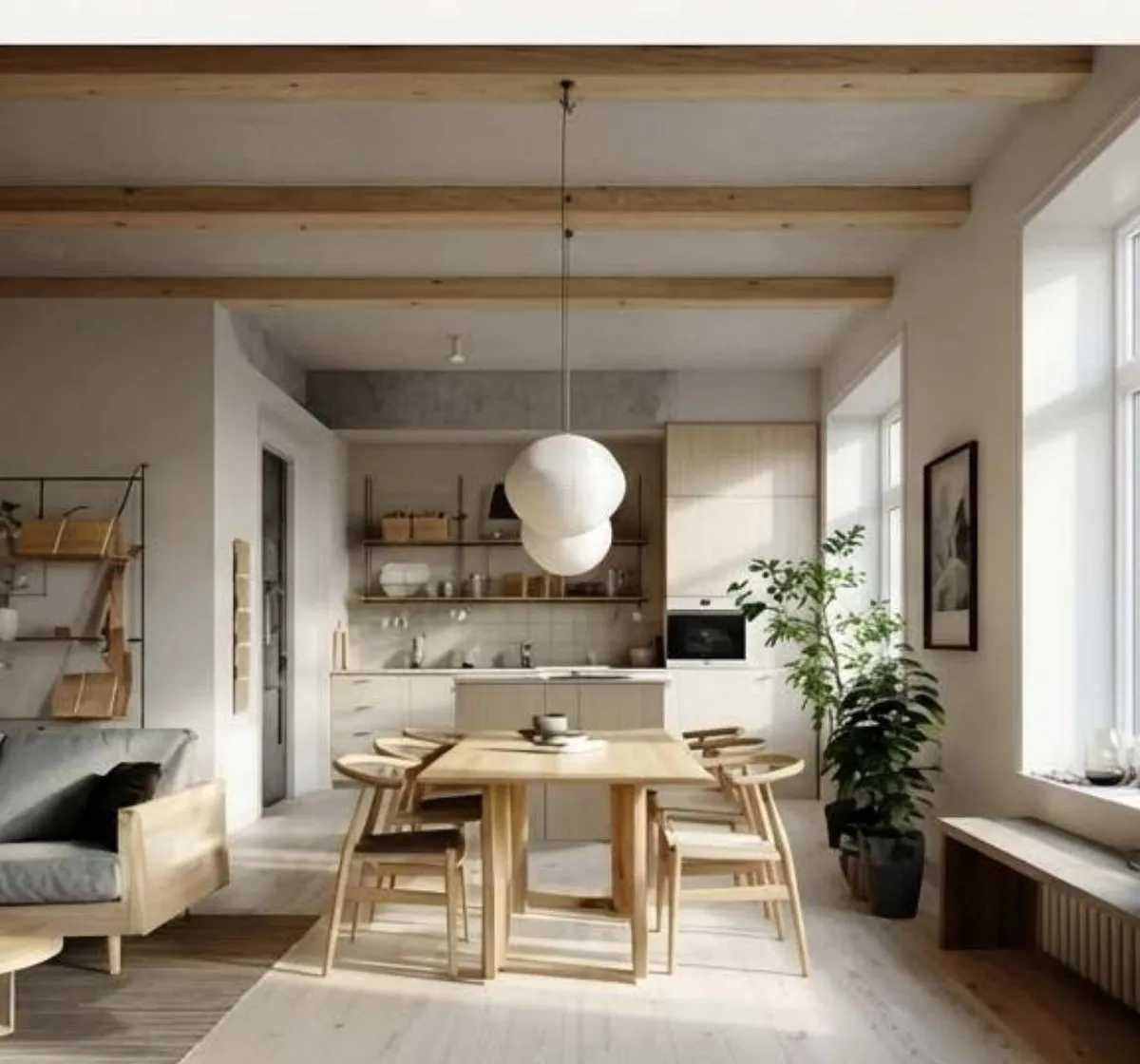 A bright dining and kitchen area with wooden table, pendant lighting, and large windows.